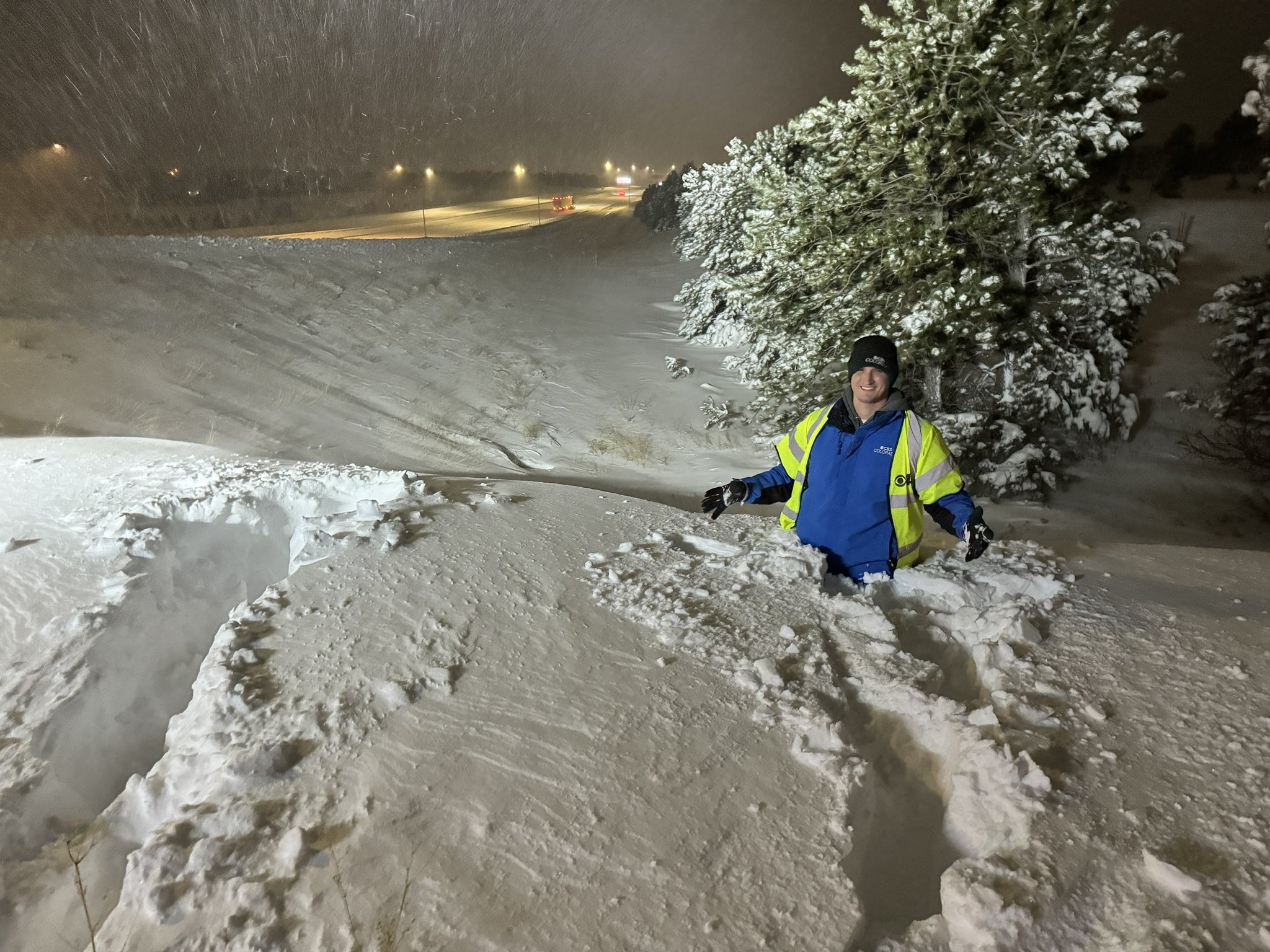 Joe Ruch reporting from deep snow beside a Colorado highway at night